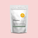 A white stand-up pouch of Organic Relaxation tea on a solid pale pink background. The packaging features a yellow circular logo for 'Impala & Peacock' and black text for the product name.