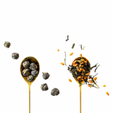 two teaspoons with green tea